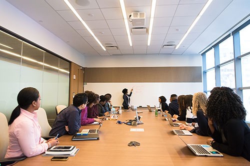 People sit around a boardroom