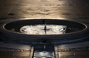 A fountain of water at night